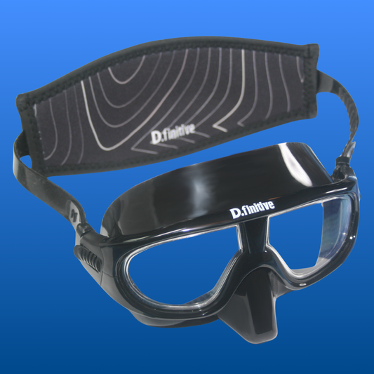 D.finitive Underwater Sports Mask - a black snorkelling mask with "D.finitive" text written in white on the top of the frame. There is a black neoprene strap on the back with a topographical wave design on, and "D.finitive" written along the bottom. Blue gradient background. Used for Underwater Hockey, Underwater Rugby and other underwater sports.